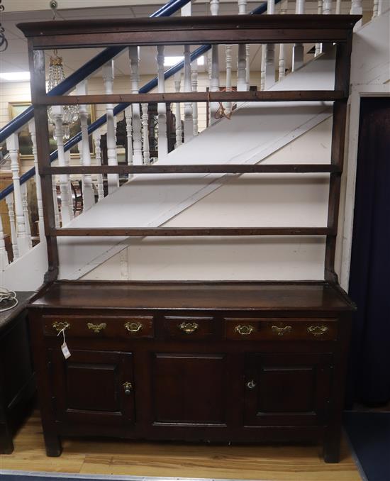 An 18th century oak dresser with open plate rack W.151cm